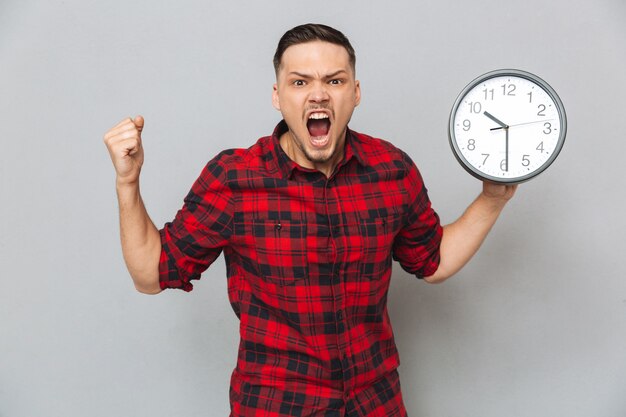 Screaming man holding clock