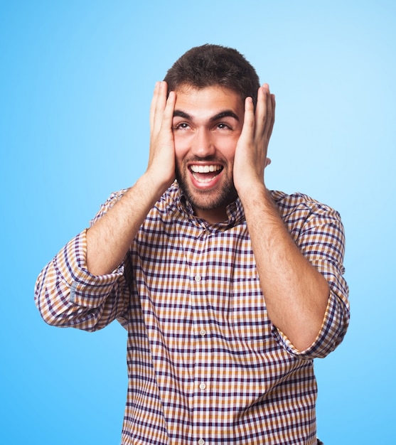 Screaming man holding his head