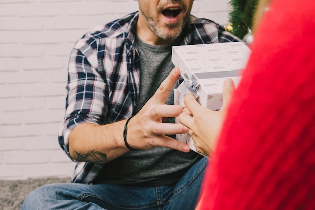 Free photo screaming man receiving present