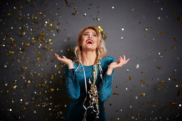 Screaming woman under shower of confetti