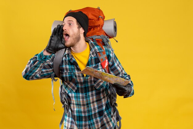 screaming young backpacker with black hat holding map