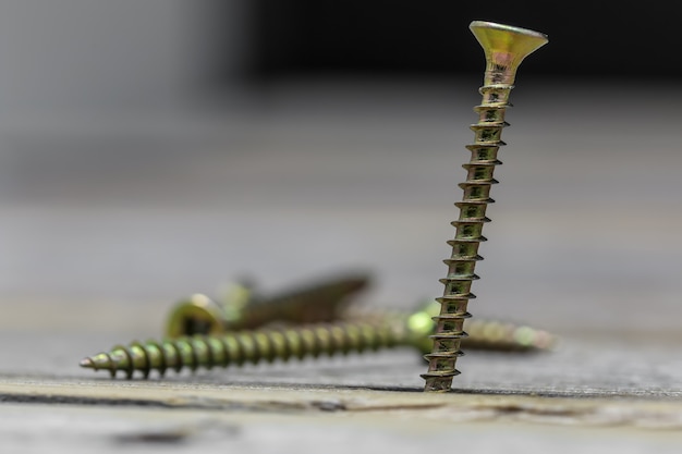 Screws on wooden wall