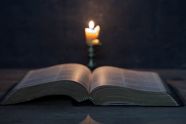 Free photo scriptures and candles on a wooden table