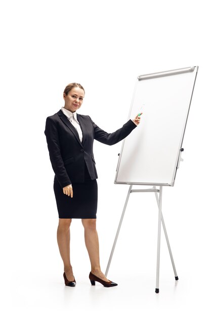 Scrolling phone. Young woman, accountant, finance analyst or booker in office suit isolated on white studio.