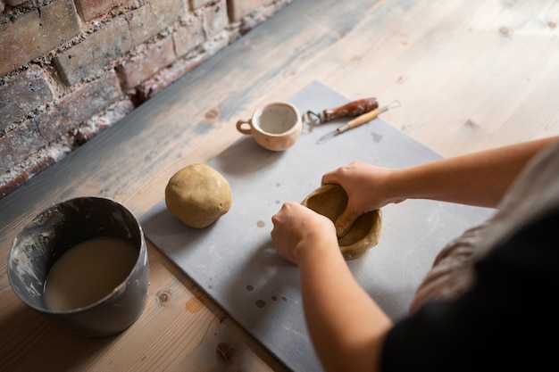 Sculptor artist working with clay in the studio