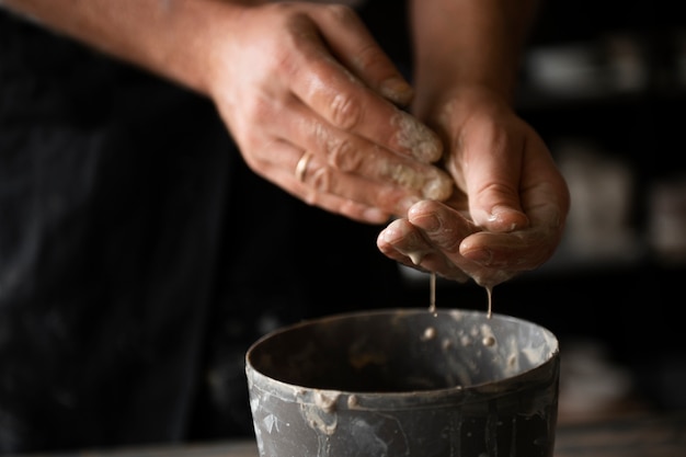 Free photo sculptor artist working with clay in the studio