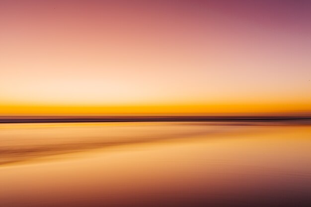 Sea during a colorful sunset with a motion effect - a cool picture for wallpapers and backgrounds