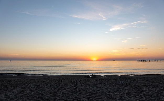 Sea embankment at sunset with a clear cloudless sky