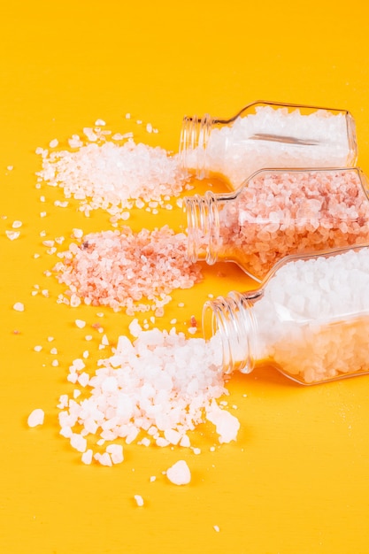 Sea salt coming out of salt shakers with himalayan salt