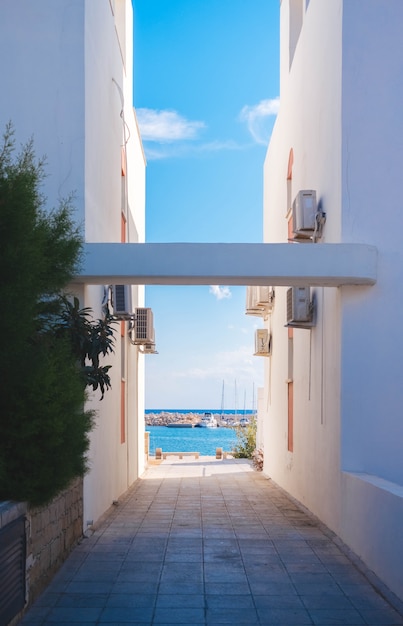 The sea through two white buildings