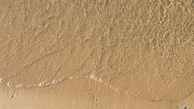 Free photo sea waves on a sandy shore