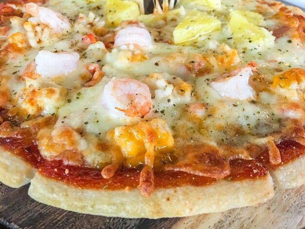 Seafood pizza on wood tray