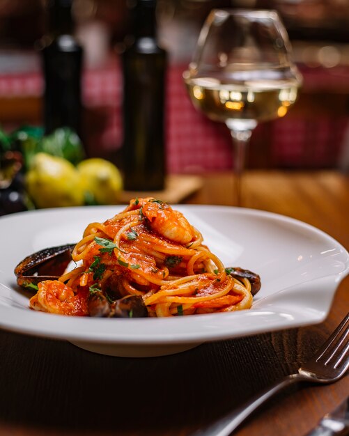 Seafood spaghetti with mussels shrimp tomato sauce and parsley