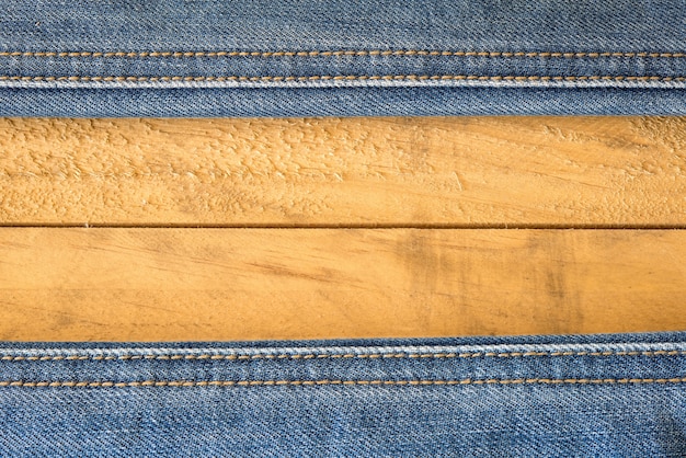 Seam of Blue Jeans on wooden Texture