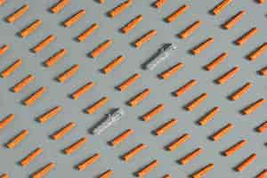 Free photo seamless pattern of red plastic dowels on gray