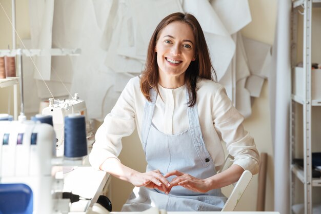 Seamstress looking and smiling