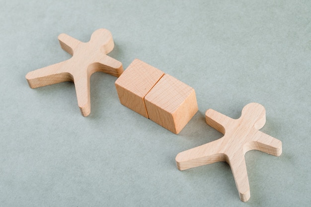 Free photo search employee concept with wooden blocks with, wooden human figure.