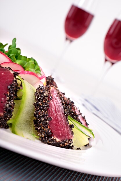 Seared tuna coated with sesame seeds close up