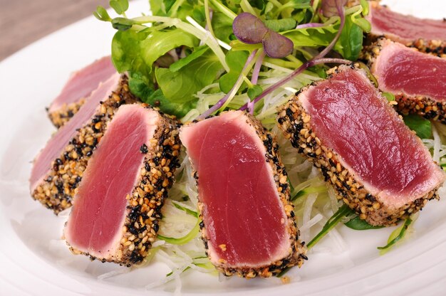 Seared tuna coated with sesame seeds with green salad