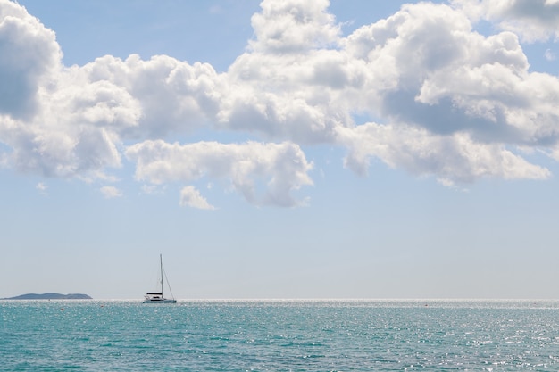 Seaside view with mountains in the distance and boats