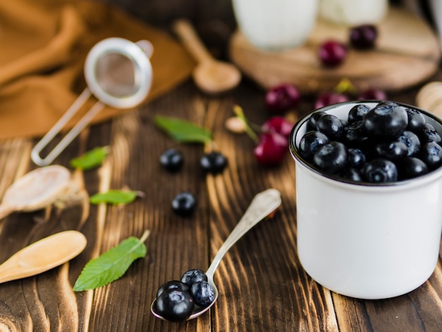 Seasonal blueberry berries in mug on table