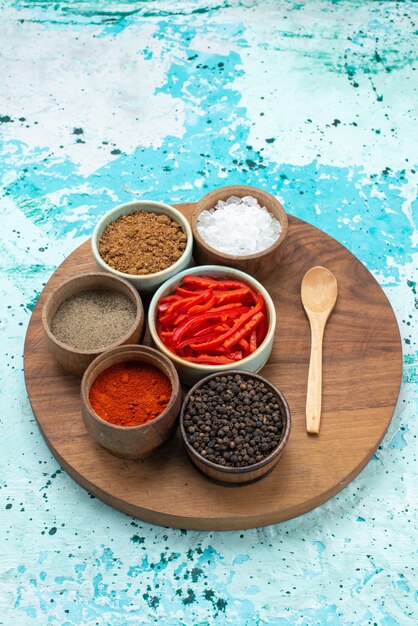 seasonings and pepper with salt on light-blue