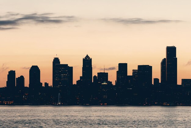 Seattle sunrise skyline silhouette view with urban office buildings.