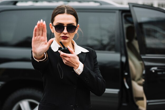 Security woman stopping photographers