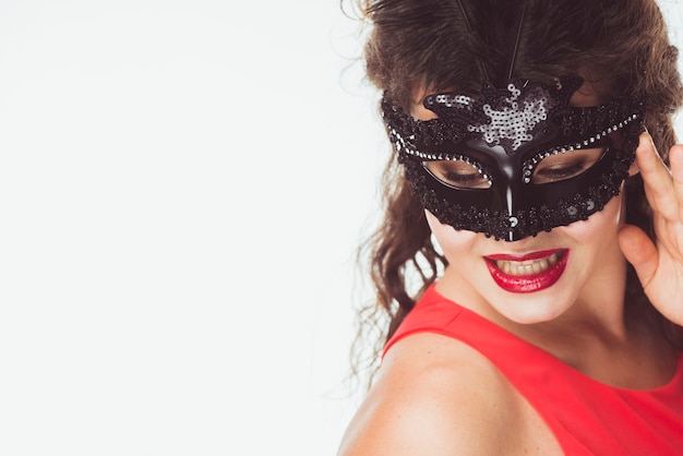 Seductive woman in black carnival mask