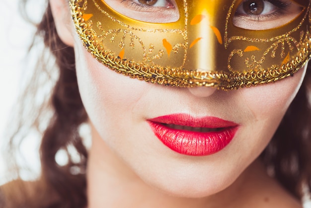 Seductive woman in golden mask