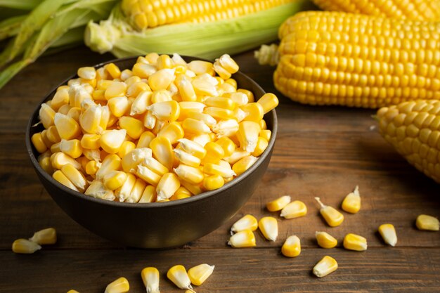 seeds and sweet corn on wooden table.