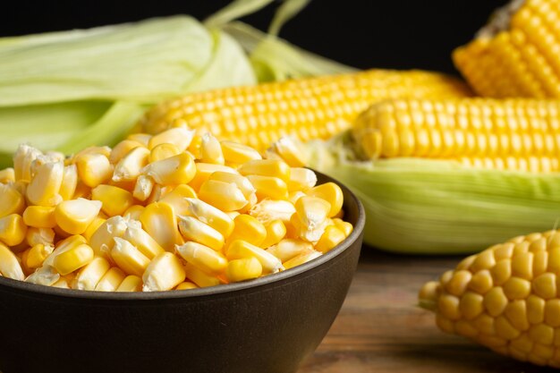 seeds and sweet corn on wooden table.