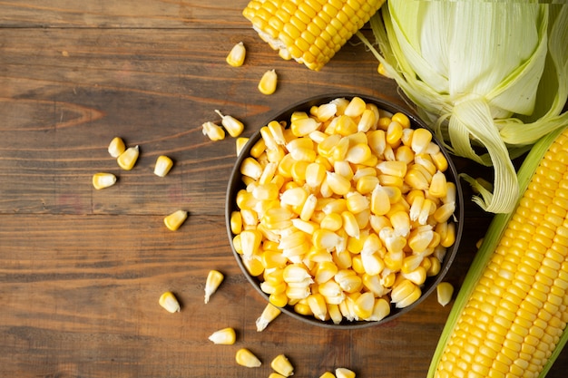 seeds and sweet corn on wooden table.