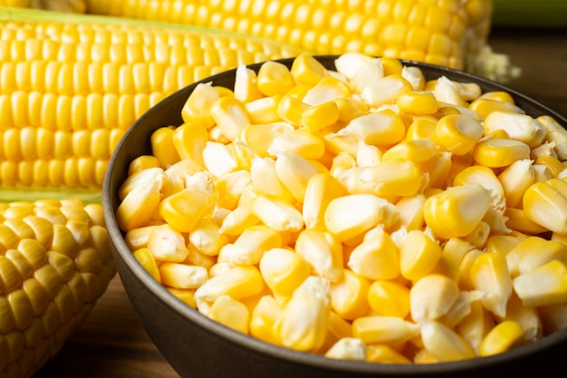 seeds and sweet corn on wooden table.