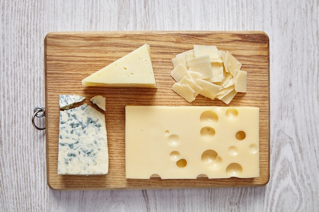 Selection of different cheese on wood plate