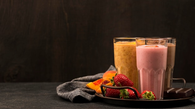 Selection of milkshake glasses with fruits and chocolate