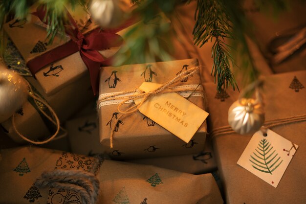 Selective focus of Christmas gift boxes surrounded by lights with a blurry background