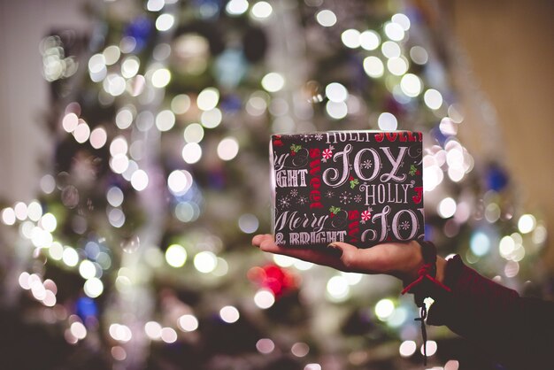 Selective focus of gift box on person's palm