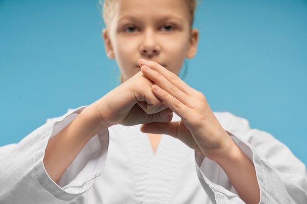 Free photo selective focus of hands of girl showing fist in studio