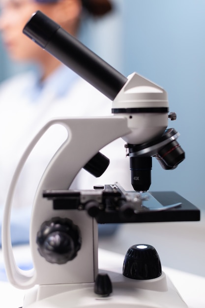 Selective focus on medical microscope standing on table in pharmacology microbiologist hospital labo...