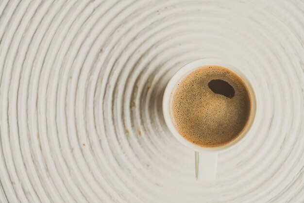 Selective focus point on black coffee in white cup 