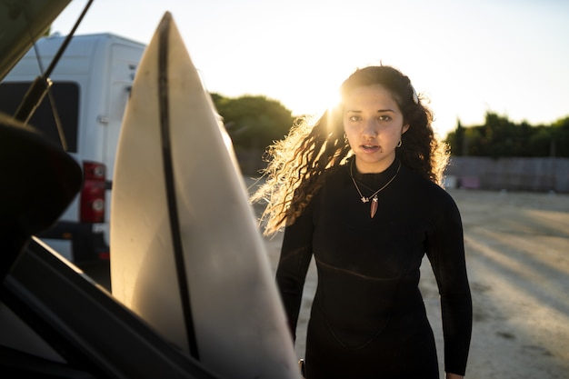 Selective focus shot of an attractive female posing under the sunlight at the beach