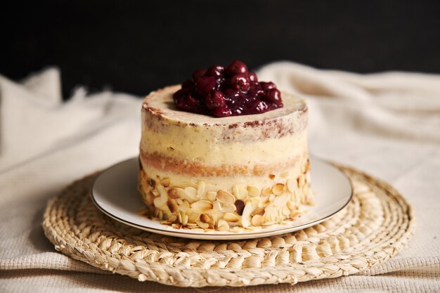 Selective focus shot of a cherry cake on a white plate