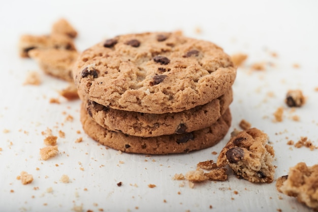 Selective focus shot of chocolate chip cookies on a white surface