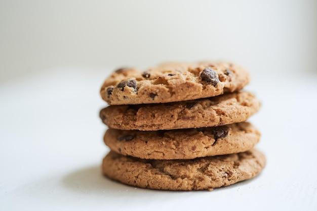 Selective focus shot of chocolate chip cookies on a white surface