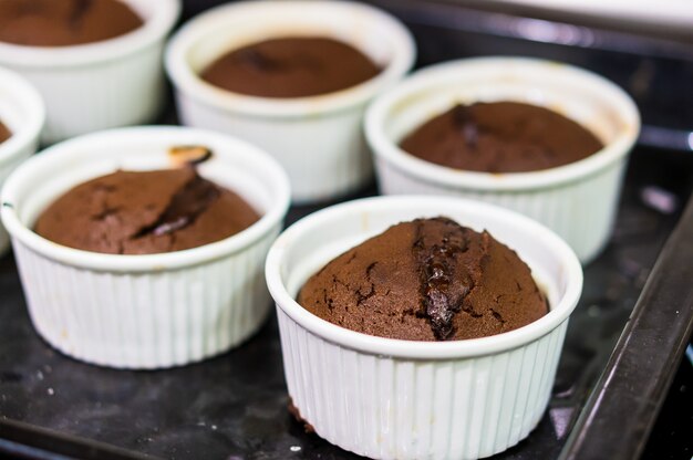 Selective focus shot of chocolate muffins in white cups