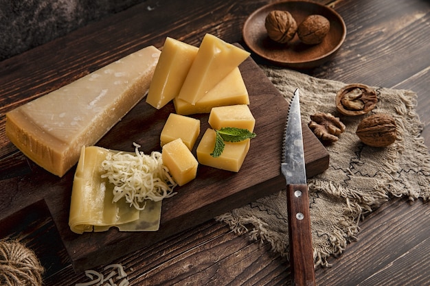 Selective focus shot of a delicious cheese platter on the table with walnuts on it