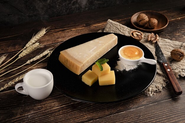 Selective focus shot of a delicious cheese platter on the table with walnuts on it