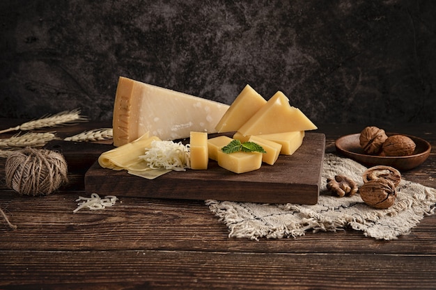 Selective focus shot of a delicious cheese platter on the table with walnuts on it