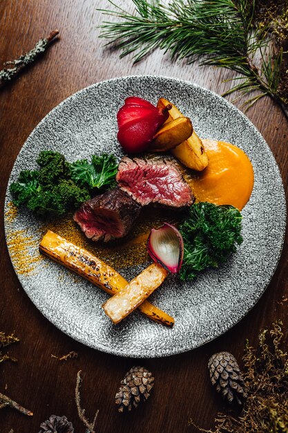 Selective focus shot of delicious cooked meat with vegetables